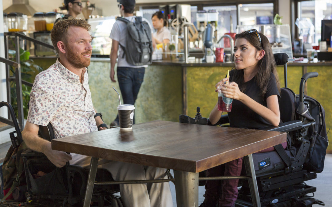 Luke Anderson, left, Maayan Ziv, right, talking at a coffee shop