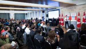 panorama of the national youth forum delegates as trudeau answers questions