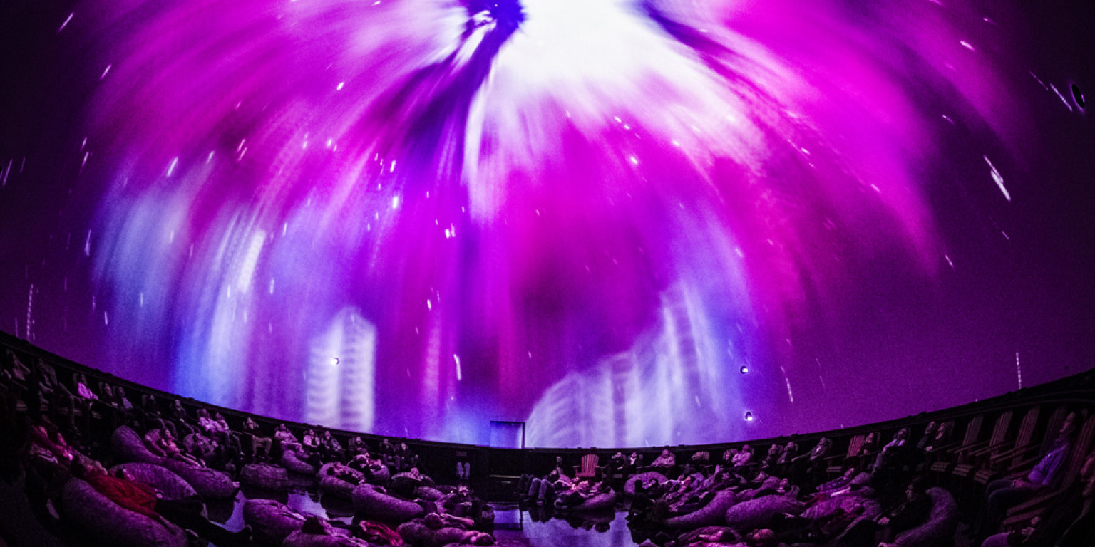 looking up at Planetarium dome with pink sky 