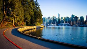 the seawall trail along the pacific ocean with view of vancouver skyline