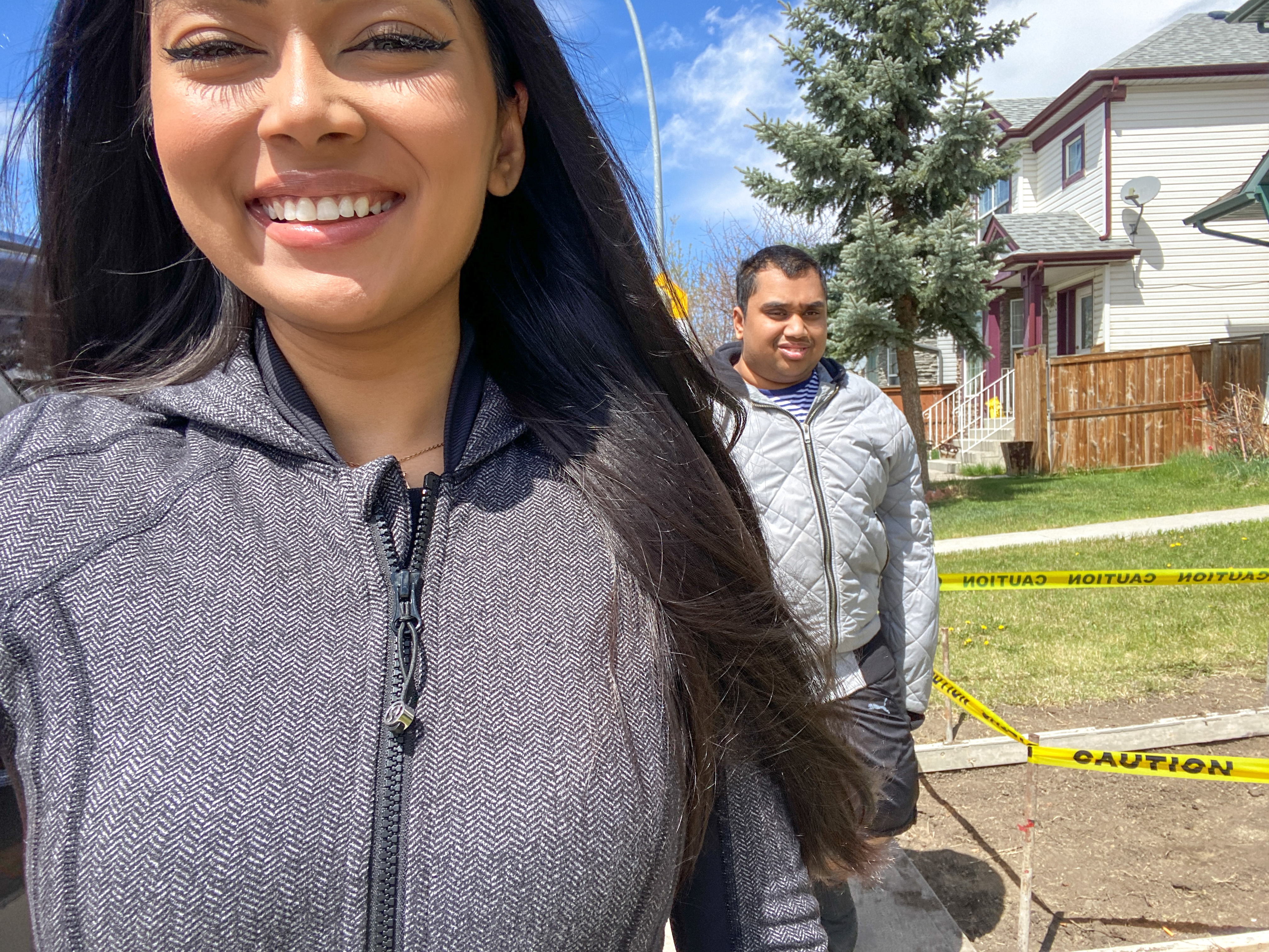 A selfie of Naz and her brother Ridwan during one of their outdoor walks. It is a beautiful day with blue skies and Naz is smiling.