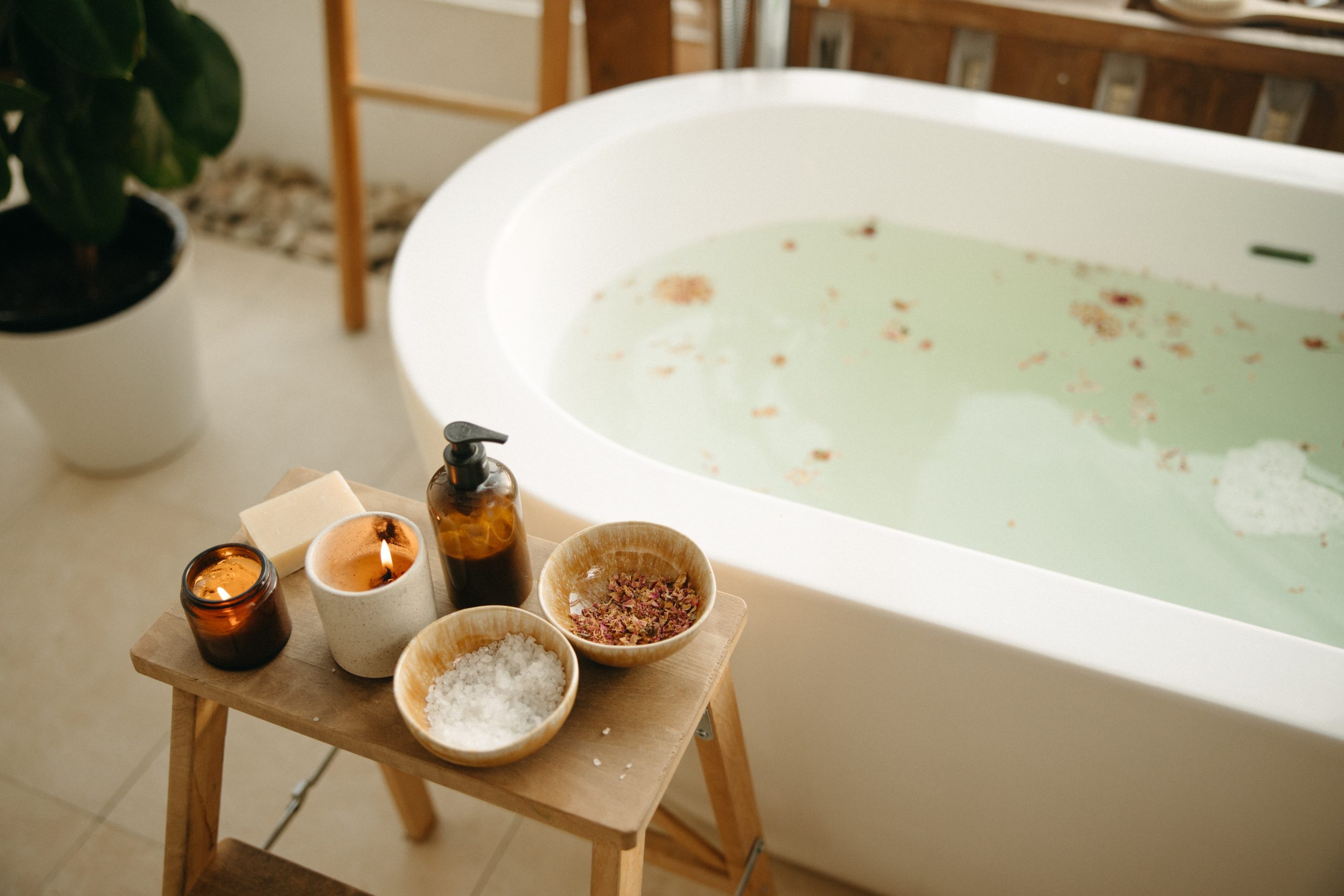 image of bath salts and candles by a full tub