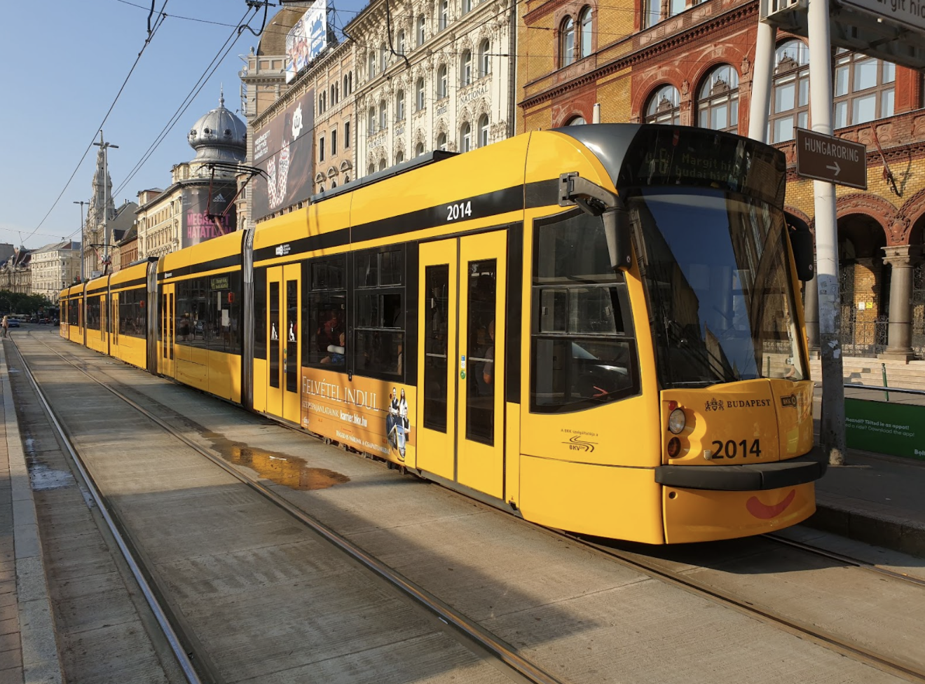 budapest streetcar. yellow and black in color and more modern