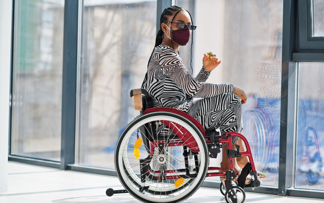 young black and disabled stylish woman in a red manual wheelchair