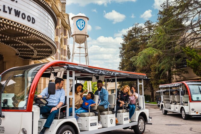 Cart filled with guests being given a tour around Warner Bro Studios