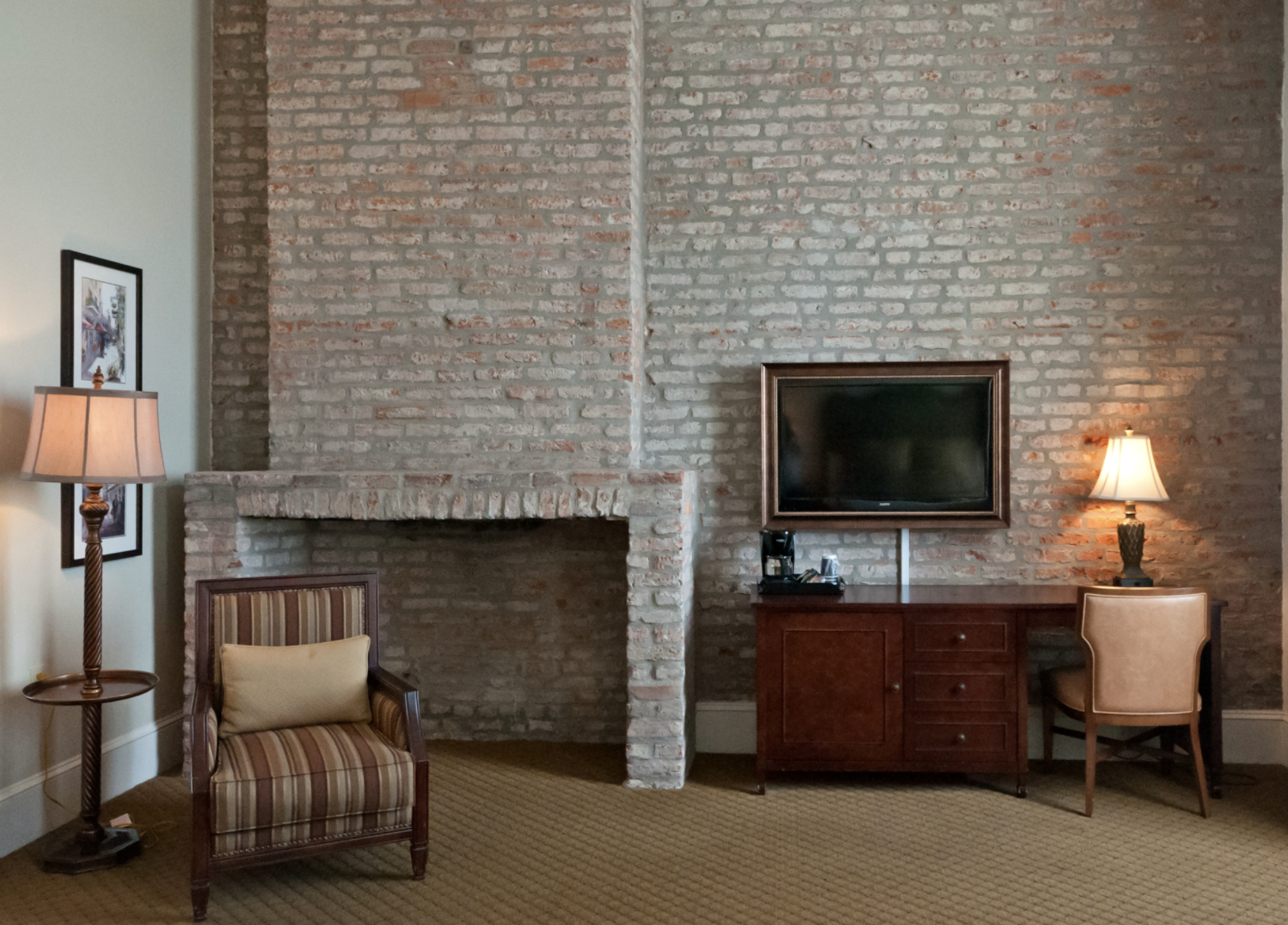 Room with exposed brick walls and victorian furnishing accents
