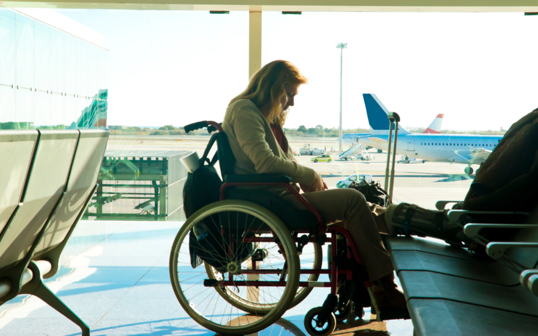 Women sitting in a wheelchair at the airport and waiting at the boarding lounge