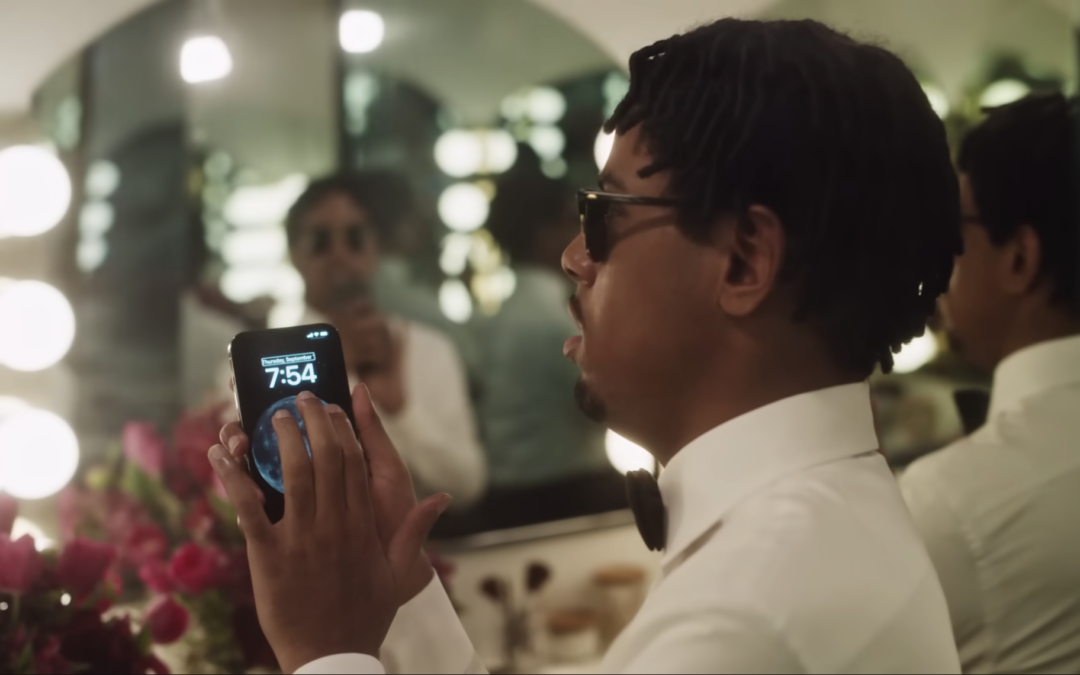 blind man in a tuxedo uses his iphone