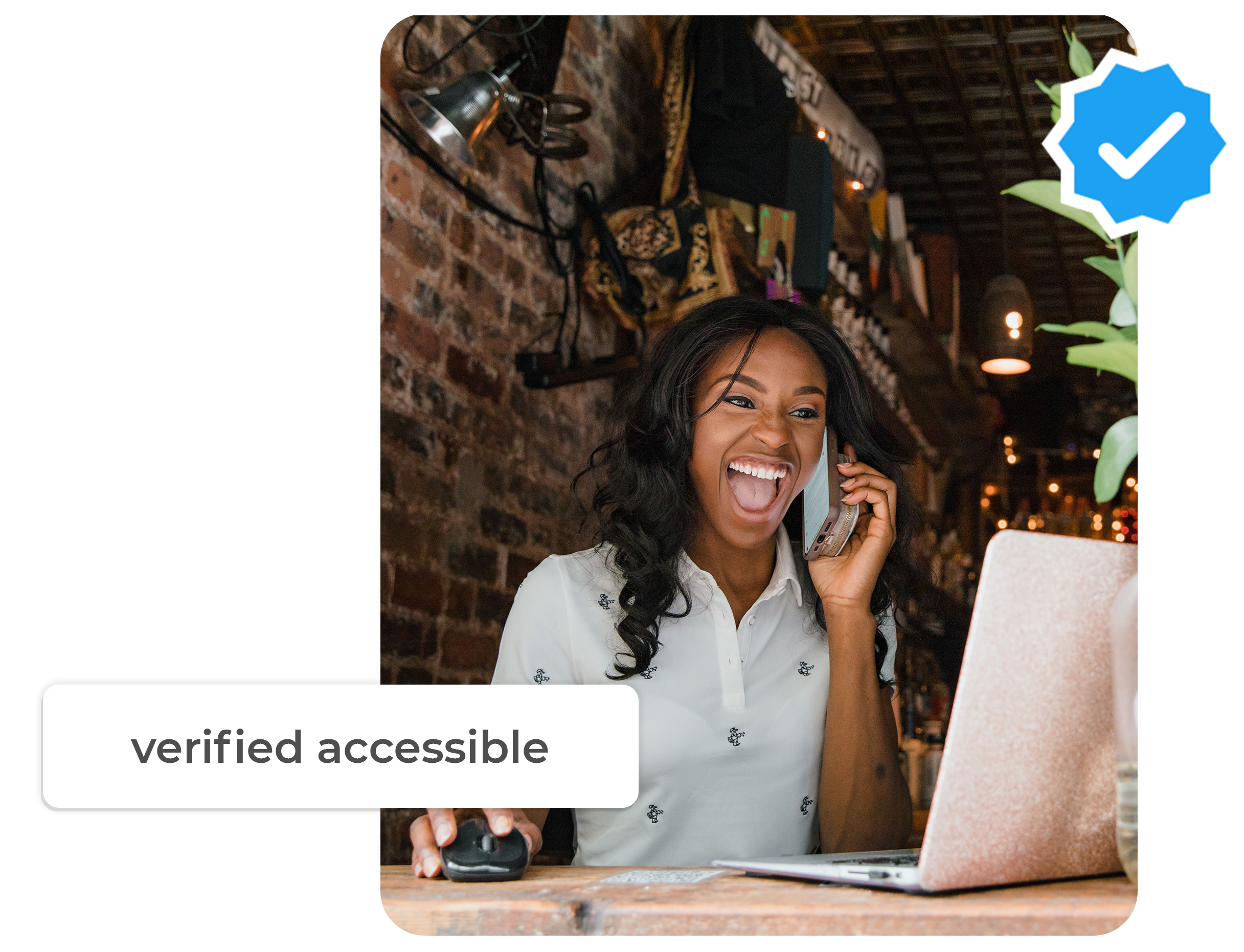 verified hero image black business owner smiles as she works on her computer in a bar setting