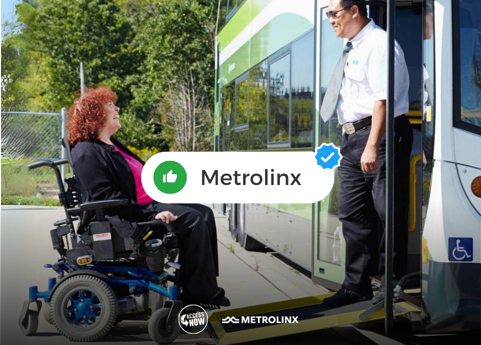 Power wheelchair user smiles as she drives onto a ramped bus greeting the driver