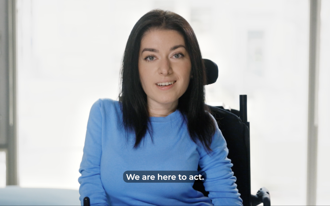 screengrab of maayan smiling in a blue shirt in a brighlty lit living room