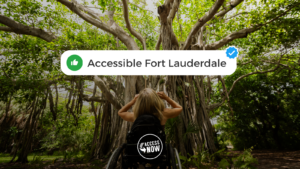 Kristin is at Hugh Taylor Birch State Park in Fort Lauderdale, Florida. Her back is facing the camera, and she is facing a giant, brown and green beautiful tree.