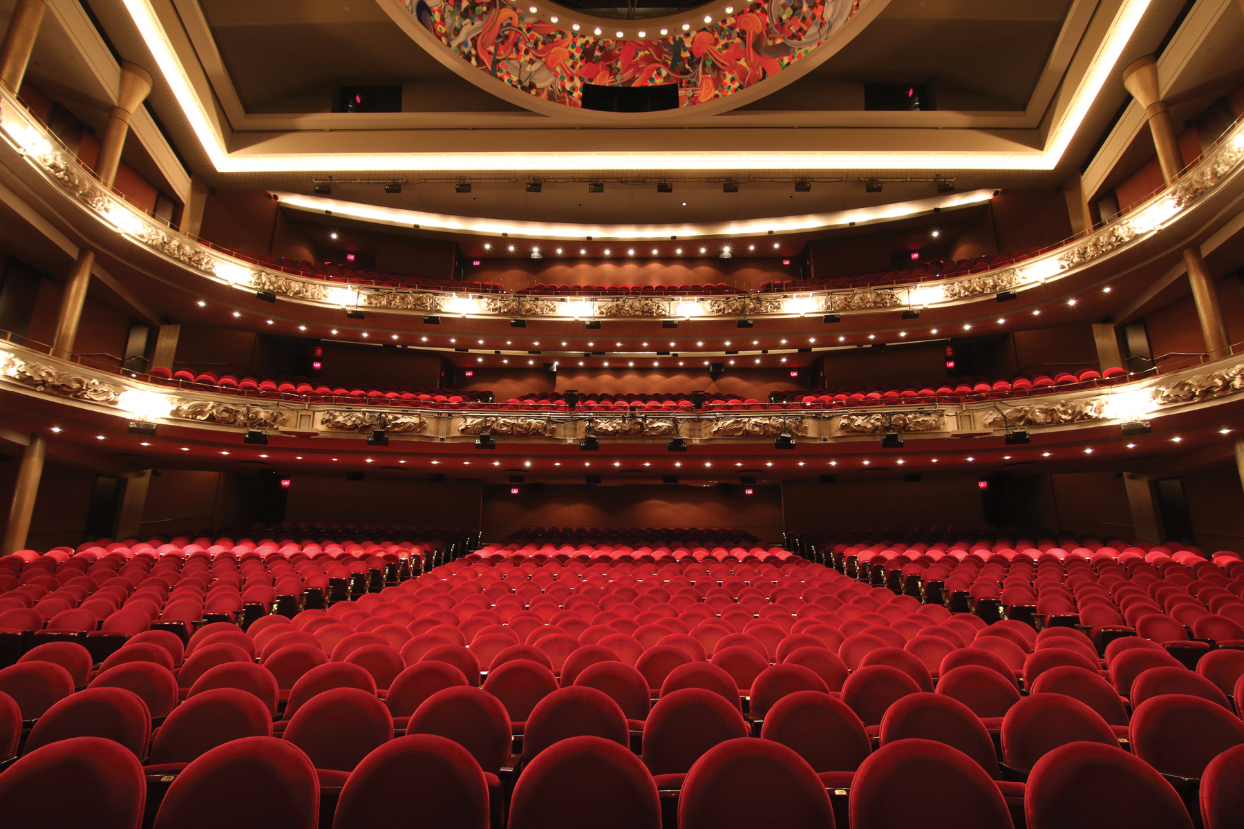 hr_1800x1200_pow-hero-1800x1200-1 interior of grand princess of wales theatre. red seating and gold lighting.