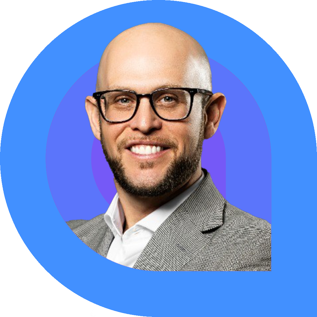 Jake Cohen, a bald man with a close beard and glasses, smiles confidently in a light grey blazer and white shirt. The portrait is framed by bold graphic rings in blue and purple on a bright pink background.