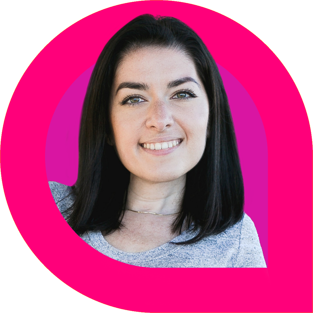 Maayan Ziv, a woman with straight dark hair, smiles confidently while wearing a light heather grey top and a delicate necklace. The portrait is framed by bold pink and magenta graphic rings, creating a vibrant and empowering visual.