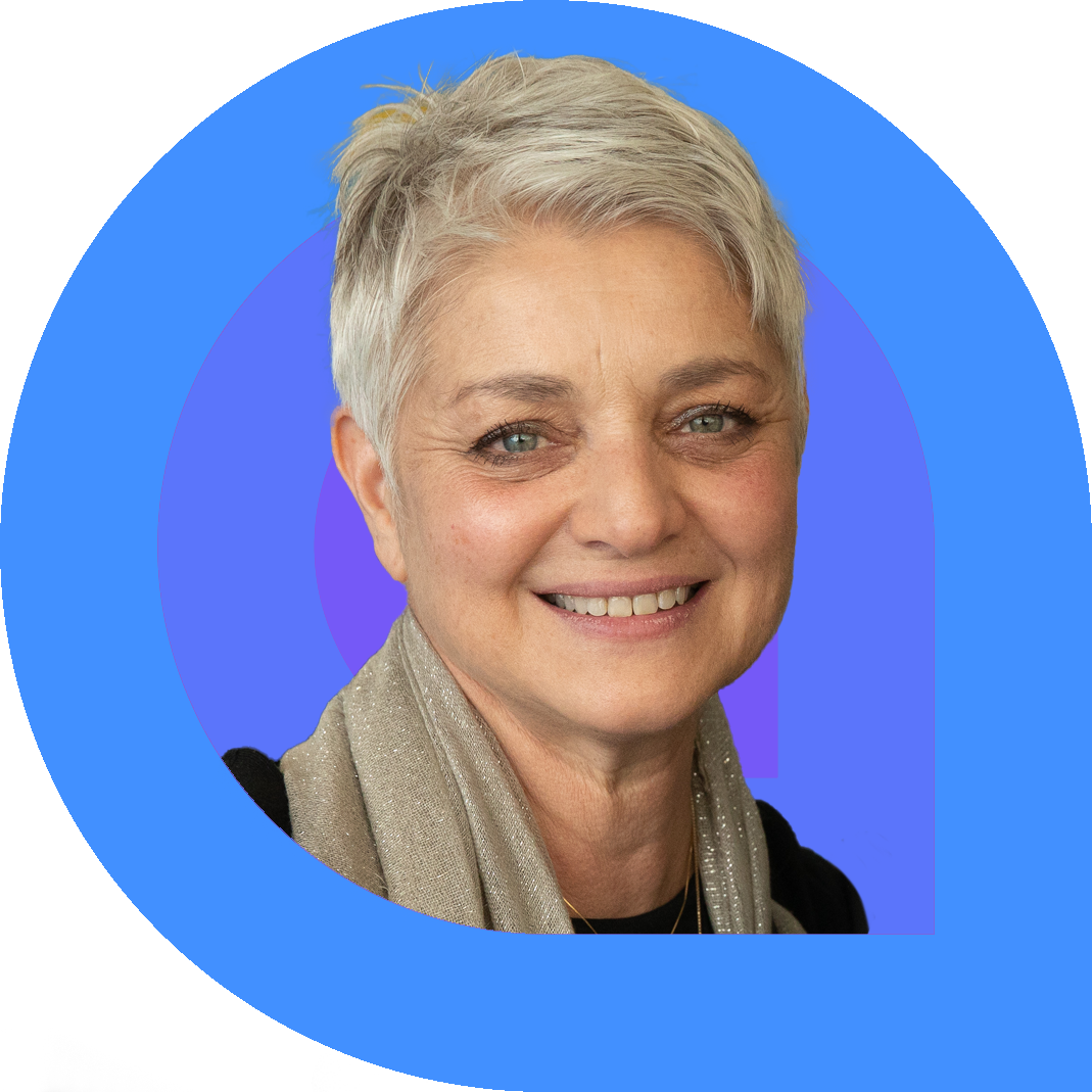 Orli Ziv, a woman with short silver hair and light eyes, smiles gently while wearing a neutral scarf over a black top. The portrait is framed by vibrant blue and purple graphic rings
