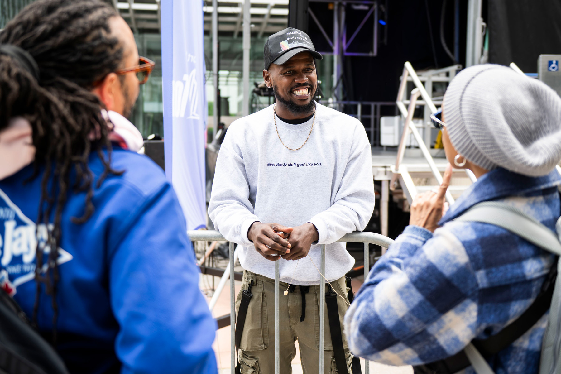 matt maxey smiles talking to two people