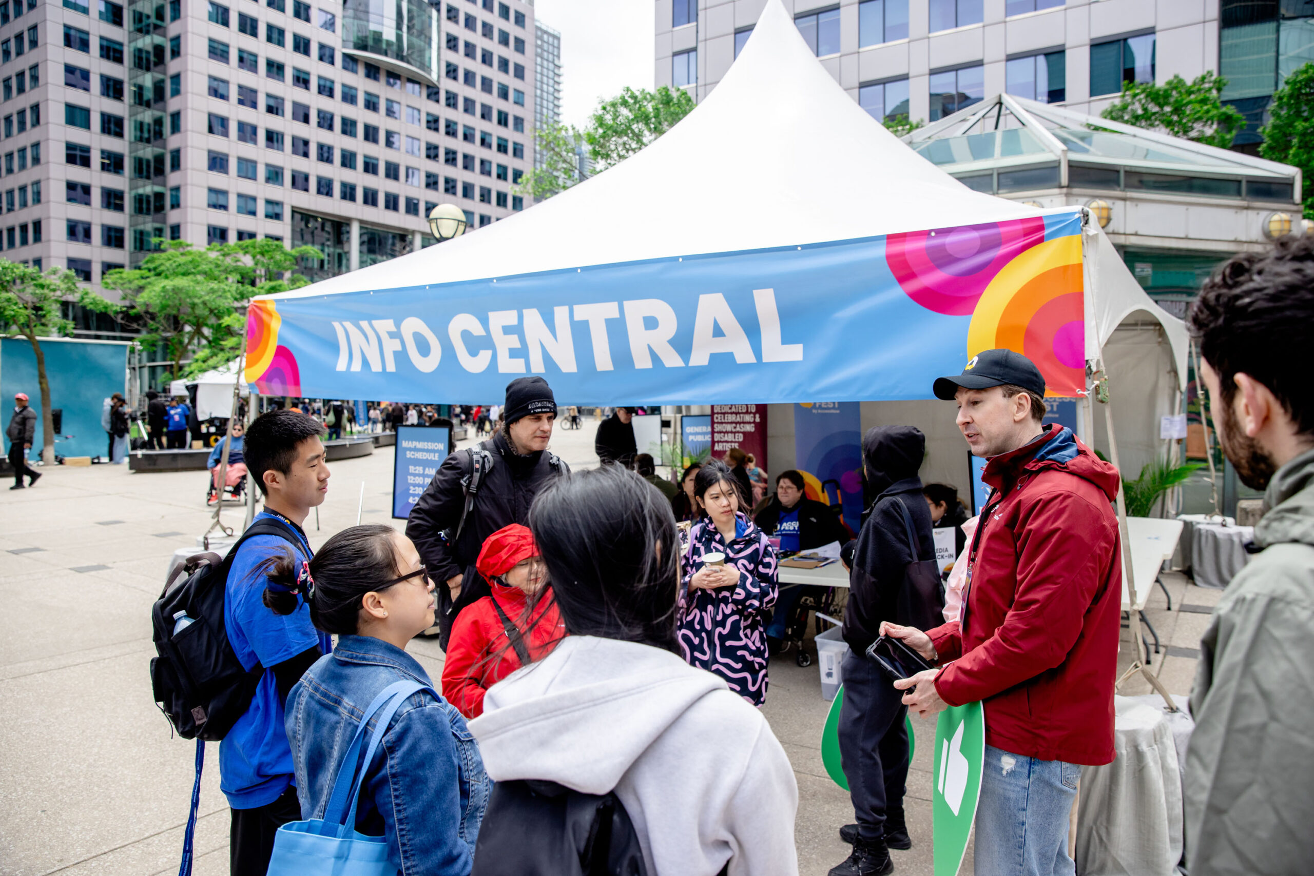 Jonathan Marriott, Director of Partnerships at AccessNow, leading the MapMissions events at AccessFest. He is standing outside and speaking with participants.