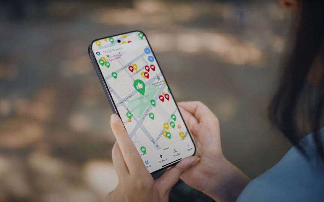 Close-up of a smartphone showing the AccessNow app map with green, yellow, and red pins marking accessibility ratings for nearby places.