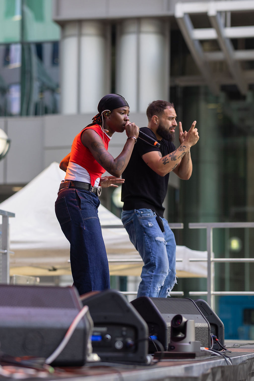 Haviah Mighty performing on stage at AccessFest 2026, doing the ASL interpretation next to her is Julian Ortiz